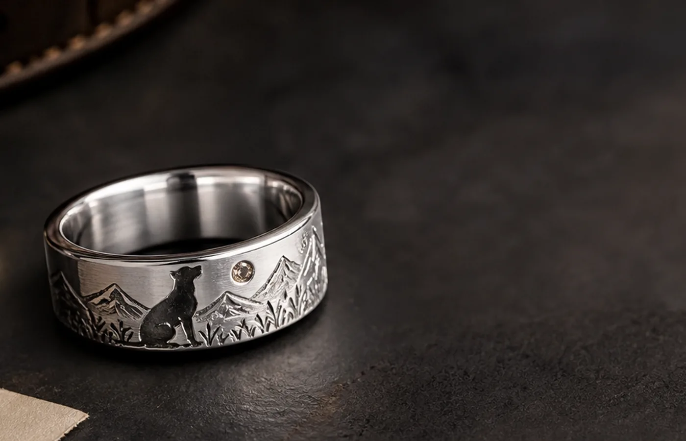 Loss of dog memorial ring with a silver band, collar tag, and quiet keepsake source materials
