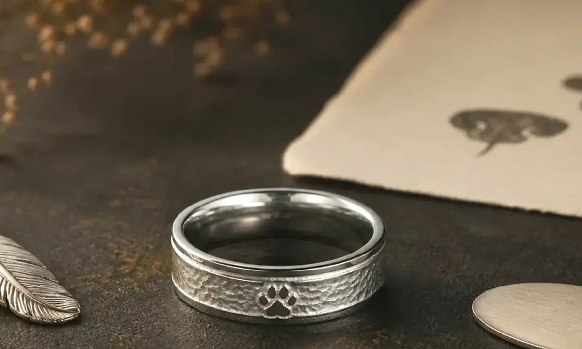 Puppy memorial ring shown with a soft silver band and a gentle early-loss tribute detail